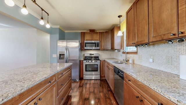 kitchen with light stone counters, brown cabinets, stainless steel appliances, dark wood-type flooring, and a sink