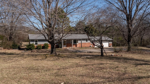 single story home with driveway, a front lawn, and an attached garage