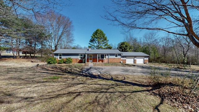 single story home with a garage and driveway