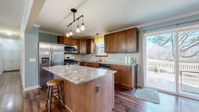 kitchen with crown molding, backsplash, appliances with stainless steel finishes, brown cabinetry, and a sink