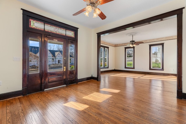 entryway with ceiling fan and light hardwood / wood-style flooring