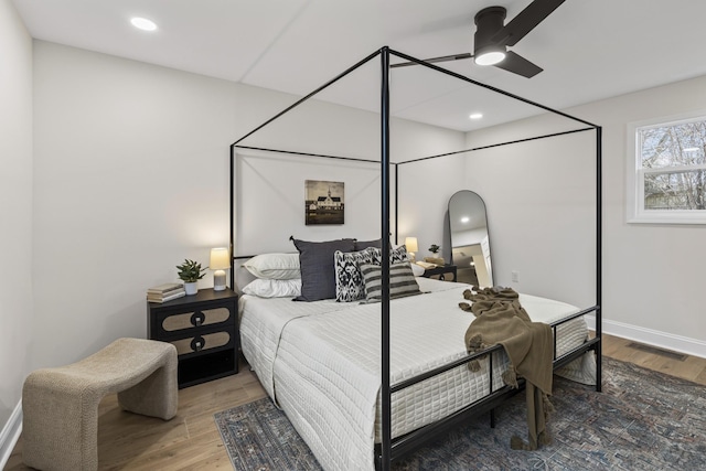 bedroom with ceiling fan and wood-type flooring