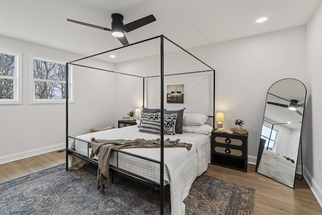 bedroom with ceiling fan and hardwood / wood-style flooring