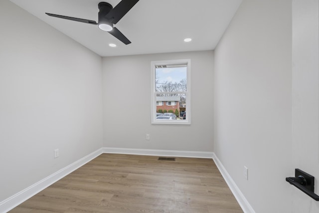 spare room featuring light hardwood / wood-style flooring and ceiling fan