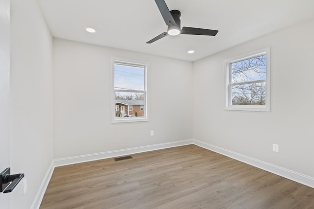 spare room featuring ceiling fan and light hardwood / wood-style flooring