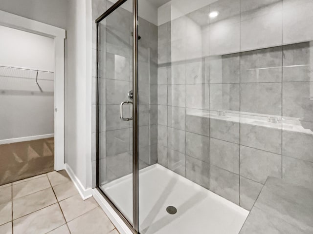 bathroom featuring tile patterned flooring and a shower with shower door