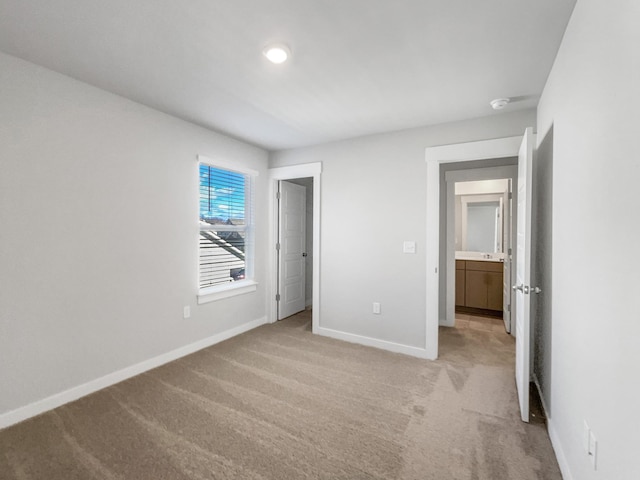 unfurnished bedroom featuring light colored carpet