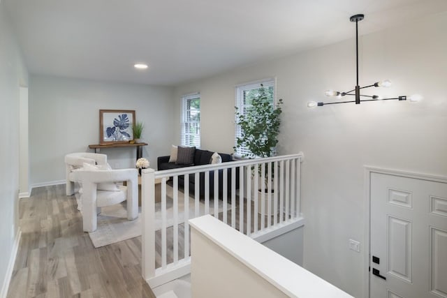 stairway featuring a chandelier and wood-type flooring