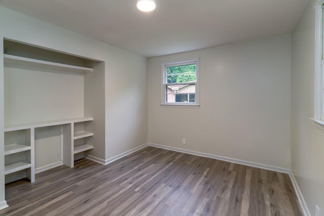 unfurnished bedroom with hardwood / wood-style floors and a closet