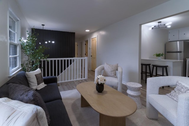 living room with light hardwood / wood-style floors and a chandelier