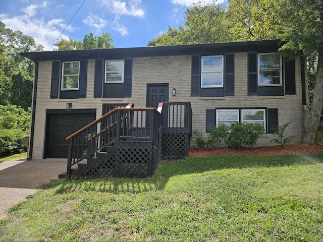 split foyer home with a front yard and a garage