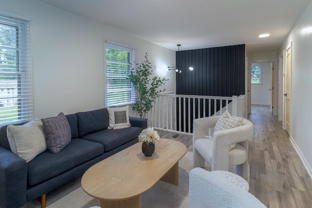 living room with a wealth of natural light and light hardwood / wood-style flooring