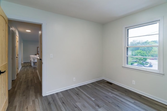 spare room featuring dark wood-type flooring