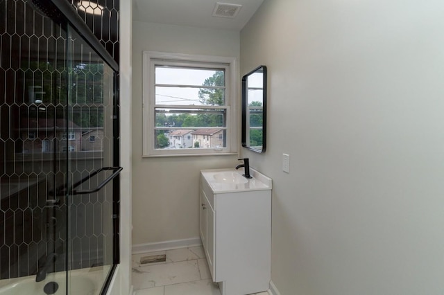 bathroom with shower / bath combination with glass door and vanity