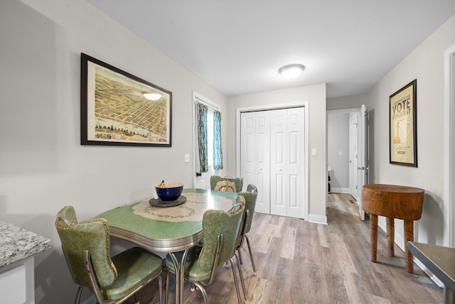 dining space featuring light wood-type flooring