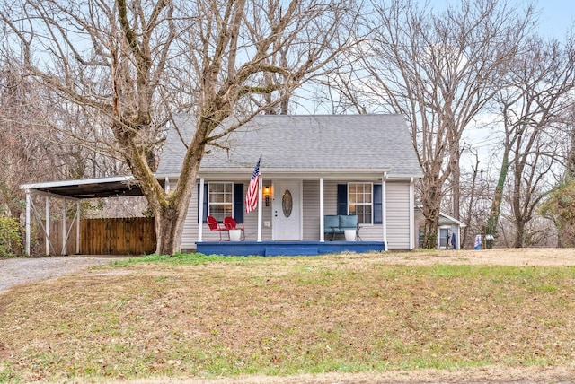 view of front of home with a front lawn and a carport