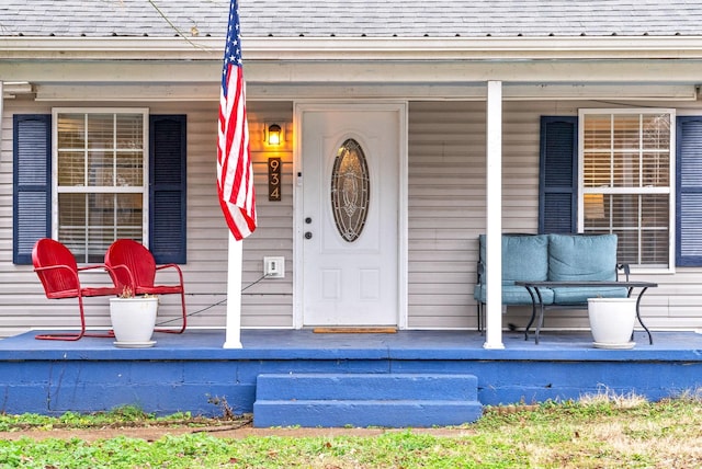 view of exterior entry featuring a porch