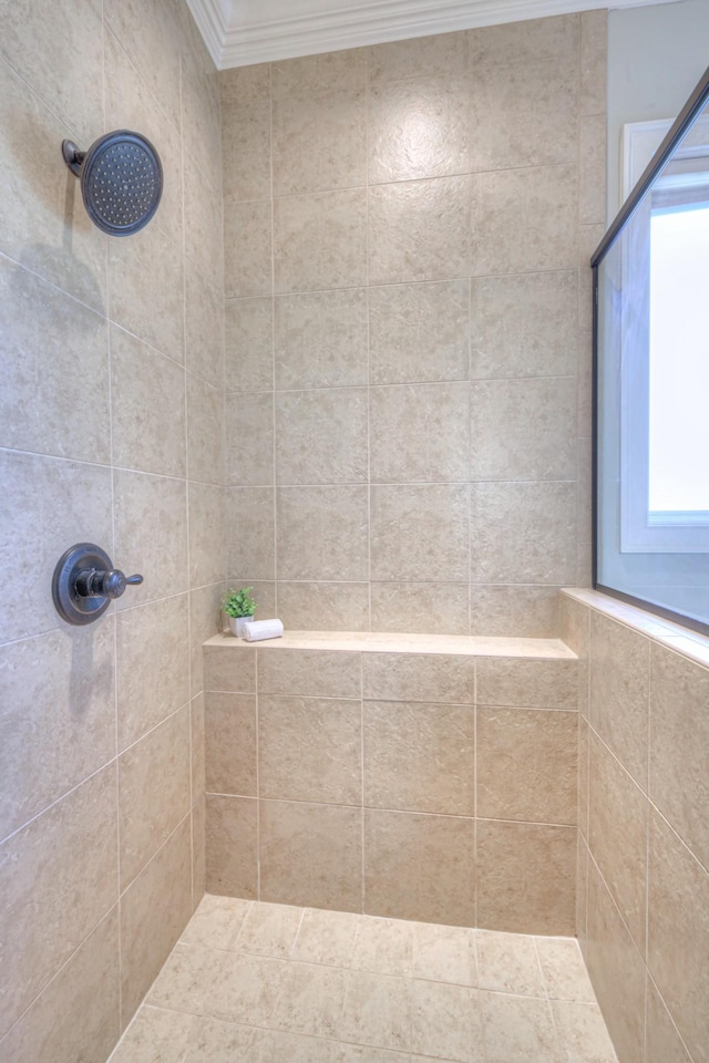 bathroom with a tile shower and ornamental molding