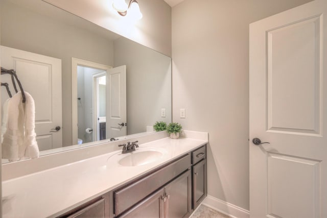 bathroom featuring tile patterned flooring, vanity, and toilet