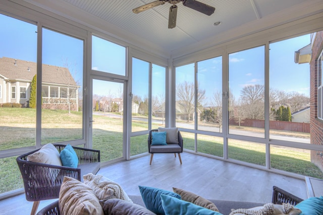 sunroom / solarium featuring a wealth of natural light and ceiling fan