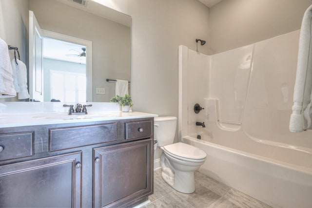 full bathroom with toilet, vanity, bathing tub / shower combination, and ceiling fan