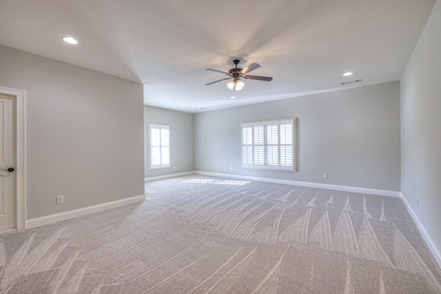 carpeted empty room featuring ceiling fan