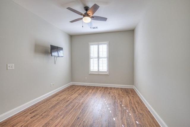 empty room featuring hardwood / wood-style flooring and ceiling fan