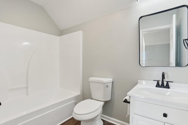 full bath with toilet, vaulted ceiling, vanity, wood finished floors, and baseboards