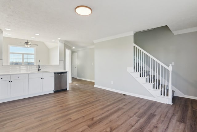 kitchen featuring dark wood-type flooring, sink, tasteful backsplash, dishwasher, and white cabinets