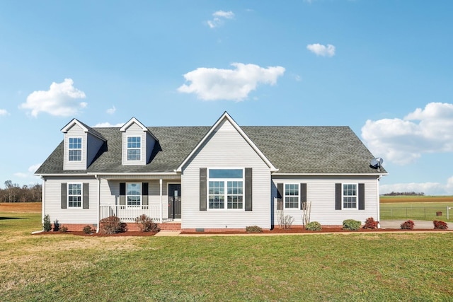 cape cod home with a front yard and a porch