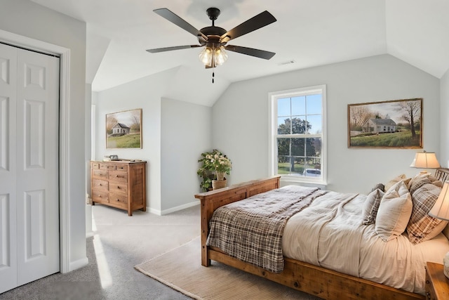 bedroom featuring lofted ceiling, visible vents, a ceiling fan, carpet flooring, and baseboards