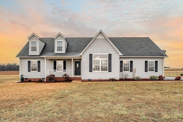 cape cod home with a porch, crawl space, a front yard, and a shingled roof