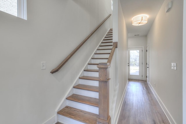 stairway featuring wood-type flooring