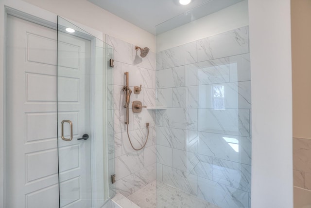 bathroom with a shower with shower door