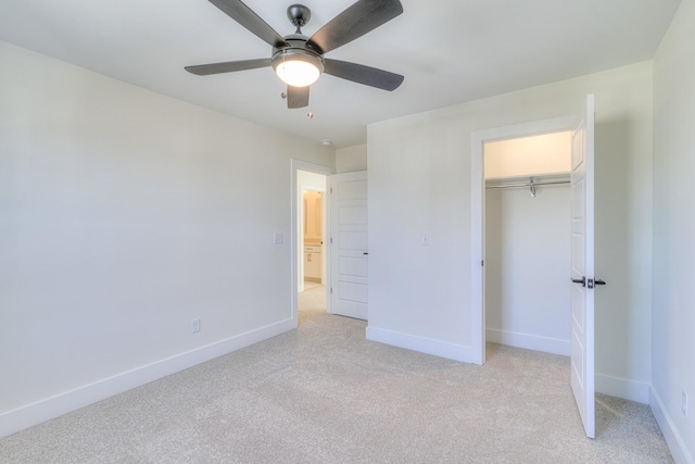 unfurnished bedroom featuring ceiling fan, light carpet, and a closet