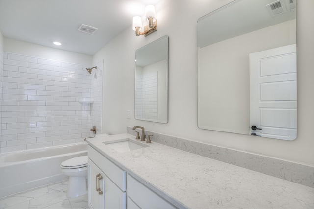 full bathroom with vanity, tiled shower / bath combo, and toilet