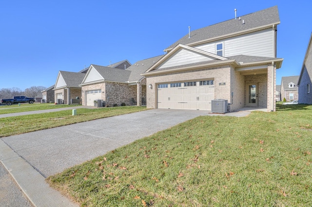 view of front of home featuring a front yard, a garage, and cooling unit