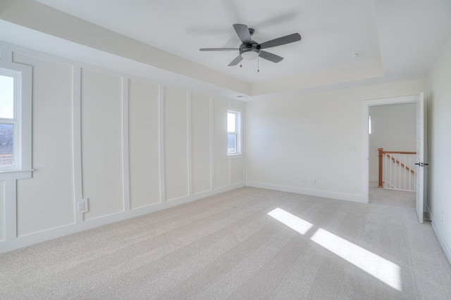 spare room featuring ceiling fan and light colored carpet