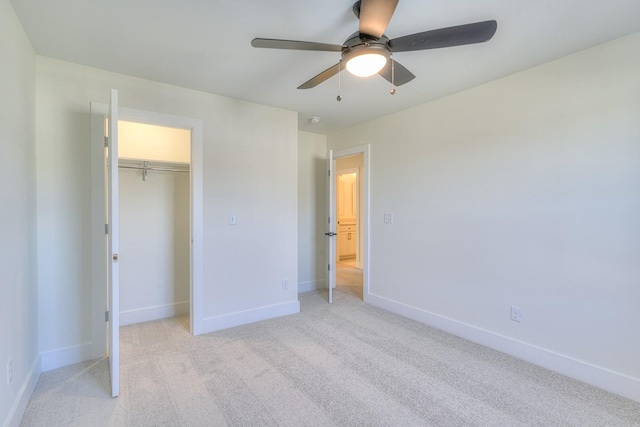 unfurnished bedroom featuring ceiling fan, light colored carpet, and a closet