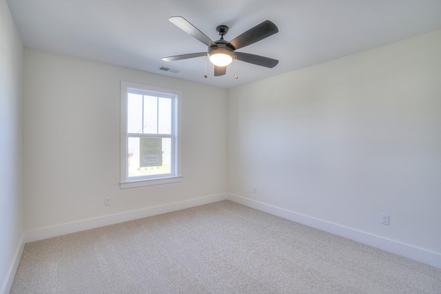 spare room featuring ceiling fan and carpet floors