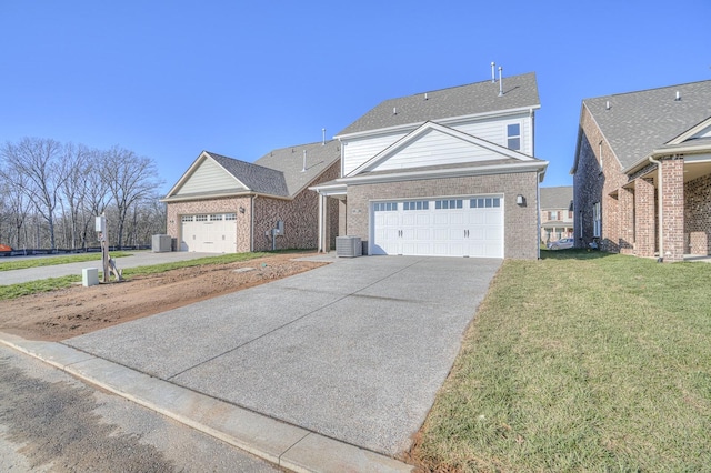 front facade featuring a front yard, a garage, and cooling unit