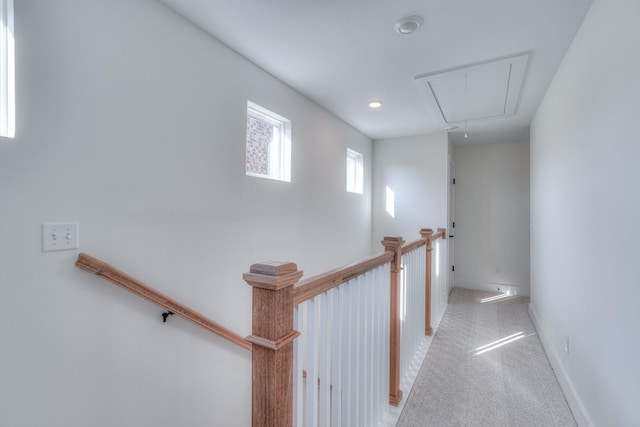 corridor featuring light colored carpet