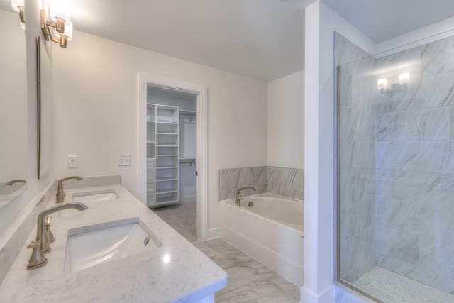 bathroom with vanity and shower with separate bathtub