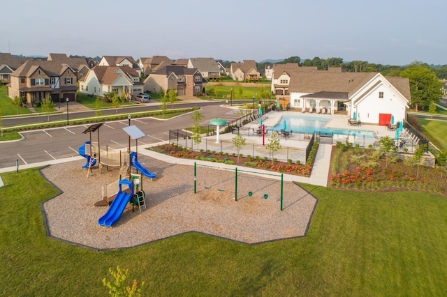 exterior space with a playground, a pool, a yard, and a patio