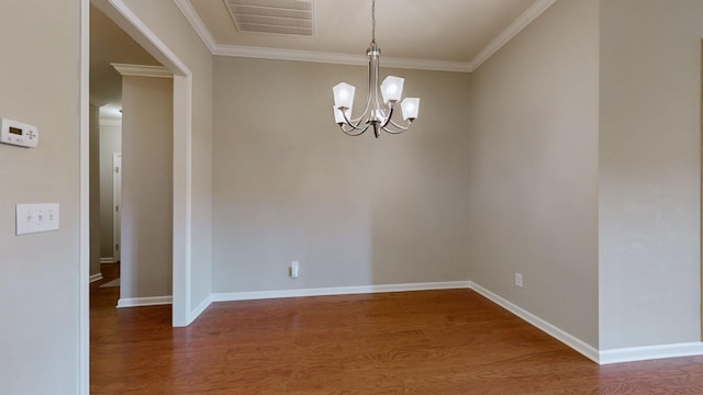 unfurnished room with dark hardwood / wood-style flooring, crown molding, and a chandelier