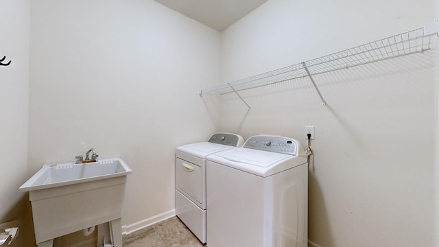 clothes washing area featuring washer and dryer and sink