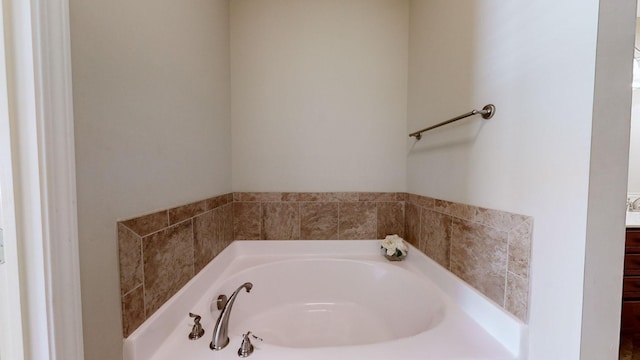 bathroom featuring vanity and a tub to relax in