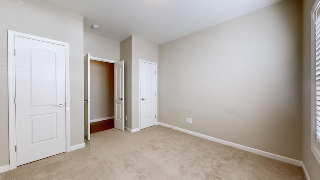 unfurnished bedroom featuring light colored carpet