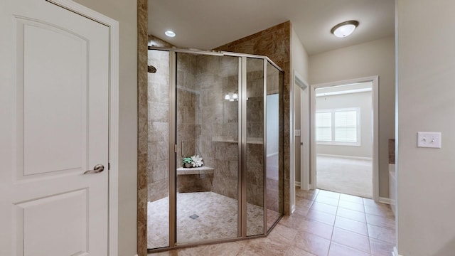 bathroom with tile patterned floors and an enclosed shower