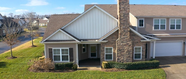 view of front of home featuring a garage and a front lawn